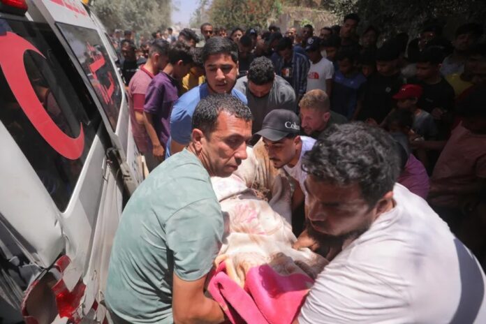 Corpos de dois palestinos mortos em ataque israelense a Deir al-Balah, em 16 de junho, são levados para ambulância (foto: Hassan Jedi – Agência Anadolu)